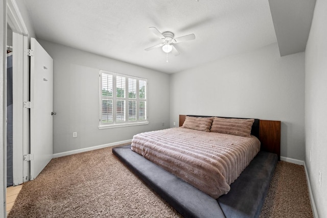 517 SW Pkwy Unit 104, College Station, TX 77840 - bedroom featuring light colored carpet, baseboards, and ceiling fan