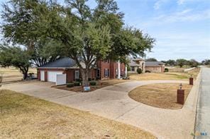 5012 Wildflower Ln, Temple, TX 76502 - view of front facade featuring curved driveway and a garage