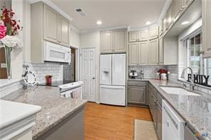 5012 Wildflower Ln, Temple, TX 76502 - kitchen featuring white appliances, backsplash, gray cabinetry, recessed lighting, and light stone countertops