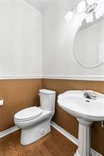 5012 Wildflower Ln, Temple, TX 76502 - half bathroom featuring toilet and wood finished floors
