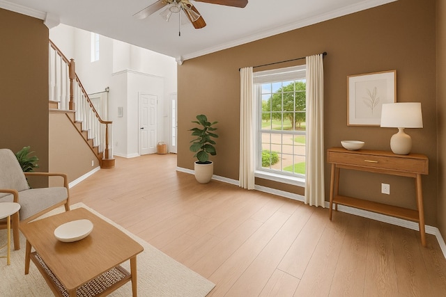 5012 Wildflower Ln, Temple, TX 76502 - living area featuring stairway, a ceiling fan, light wood-type flooring, and ornamental molding