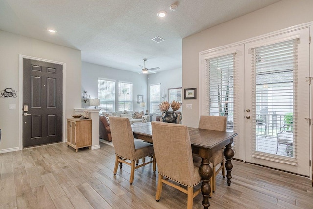 dining area featuring light wood-style floors, a ceiling fan, and recessed lighting