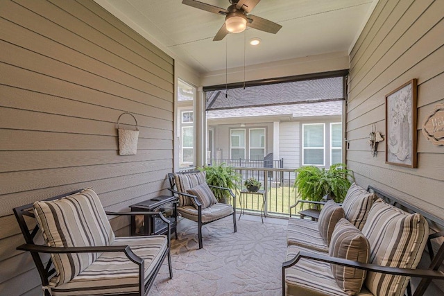 sunroom featuring ceiling fan