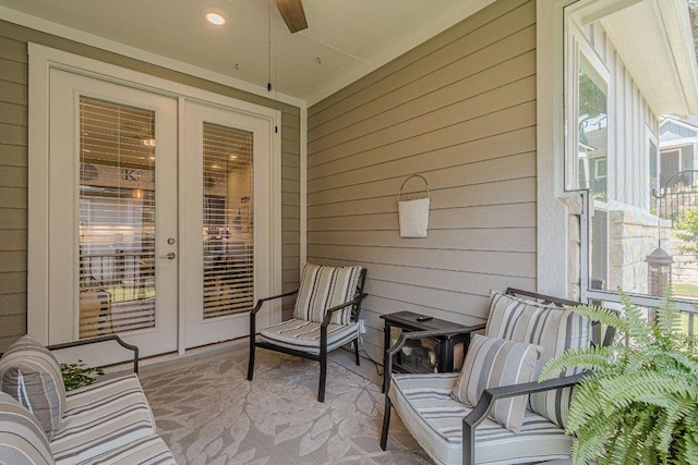 sunroom / solarium featuring french doors and a ceiling fan