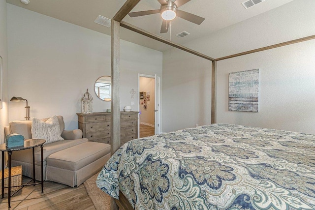 bedroom with wood finished floors, vaulted ceiling, and ceiling fan
