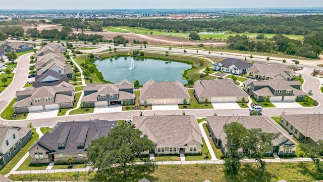 aerial view of property's location featuring a large body of water and nearby suburban area