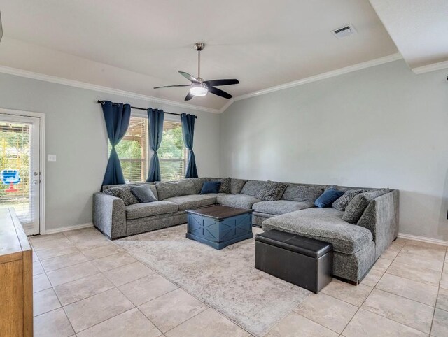 living room featuring light tile patterned flooring, ornamental molding, a ceiling fan, and baseboards