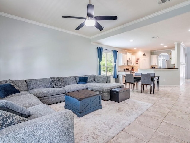 living area featuring ornamental molding, ceiling fan, light tile patterned floors, recessed lighting, and arched walkways