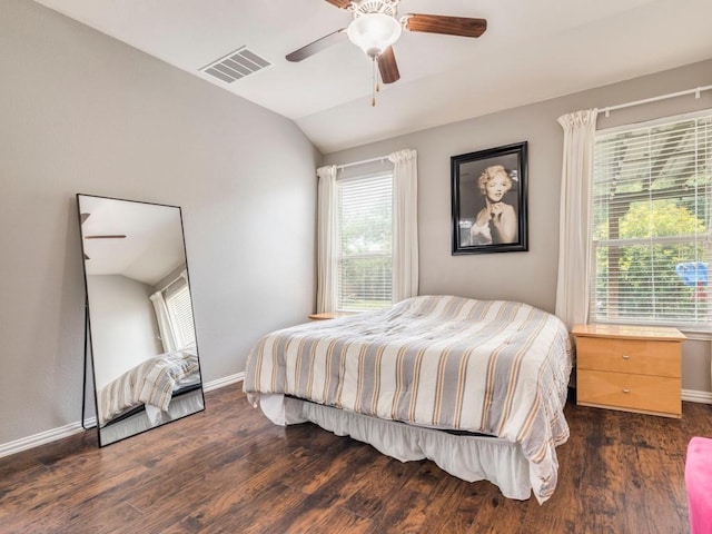 bedroom featuring lofted ceiling, dark wood-style flooring, multiple windows, and baseboards