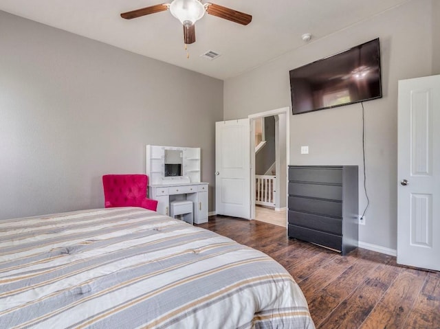 bedroom with wood finished floors, baseboards, and ceiling fan