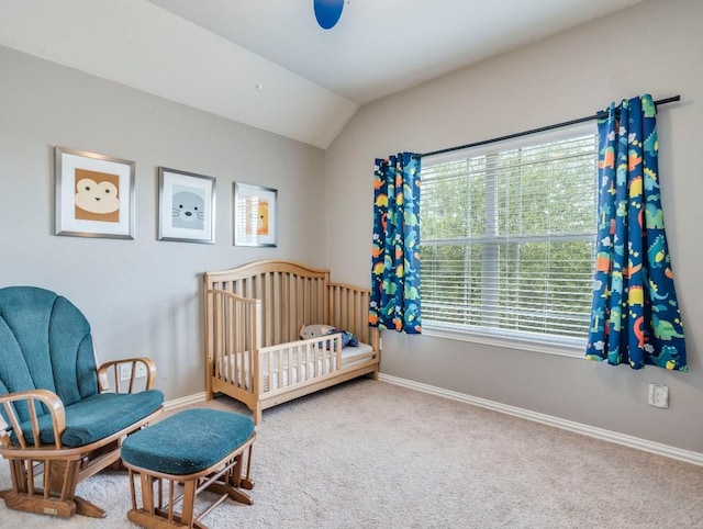 carpeted bedroom with lofted ceiling and baseboards