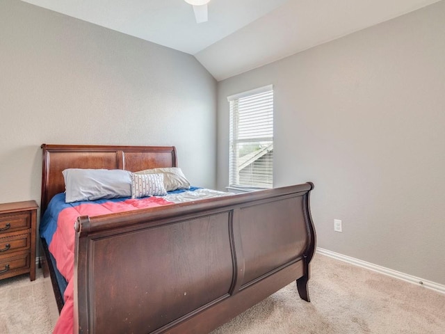 bedroom featuring light carpet, lofted ceiling, baseboards, and ceiling fan