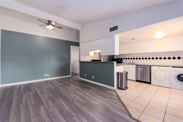 5601 Woodrow Ave Unit 109, Austin, TX 78756 - kitchen with dishwasher, white cabinetry, light wood-style floors, a ceiling fan, and washing machine and clothes dryer