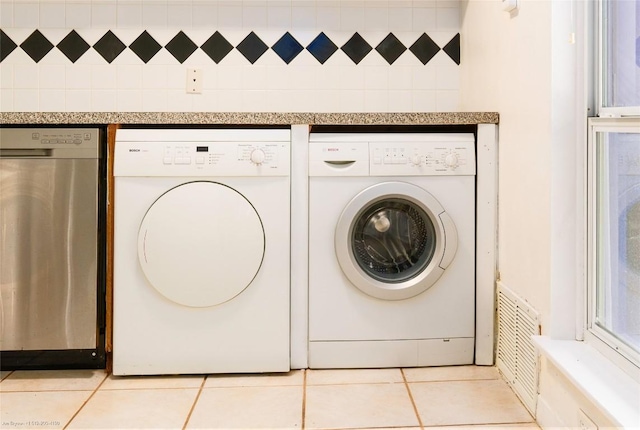 5601 Woodrow Ave Unit 109, Austin, TX 78756 - laundry room featuring washer and clothes dryer and light tile patterned floors