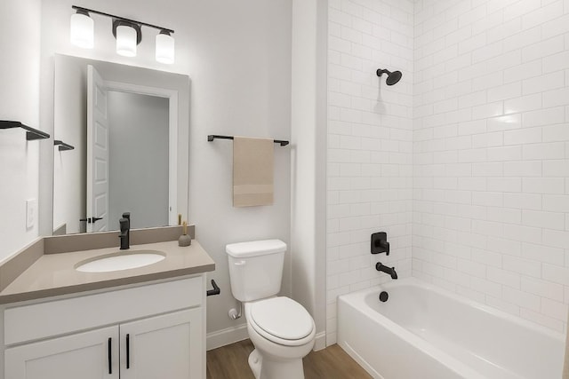 303 Kings Pine Dr, Dripping Springs, TX 78620 - bathroom with toilet, wood finished floors, shower / bathtub combination, vanity, and baseboards