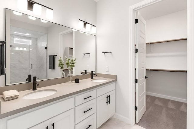303 Kings Pine Dr, Dripping Springs, TX 78620 - bathroom with a shower stall, a walk in closet, double vanity, and baseboards