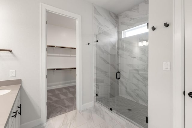 303 Kings Pine Dr, Dripping Springs, TX 78620 - full bath with marble finish floors, a marble finish shower, a spacious closet, baseboards, and vanity