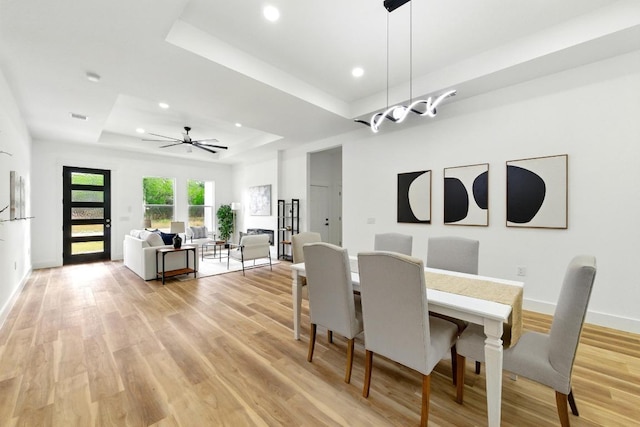 109 E Pauwela Ln, Bastrop, TX 78602 - dining space with a tray ceiling, light wood-style floors, recessed lighting, baseboards, and a ceiling fan