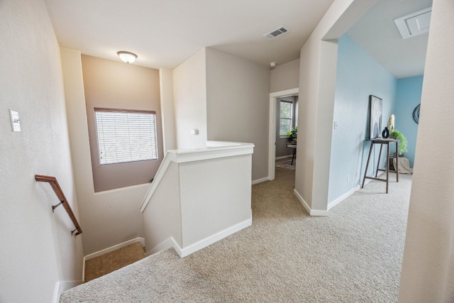 corridor featuring an upstairs landing, carpet flooring, and baseboards