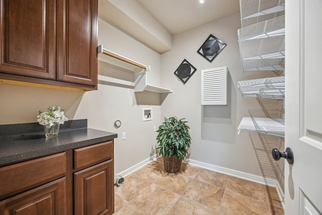 clothes washing area with cabinet space, hookup for a washing machine, and baseboards