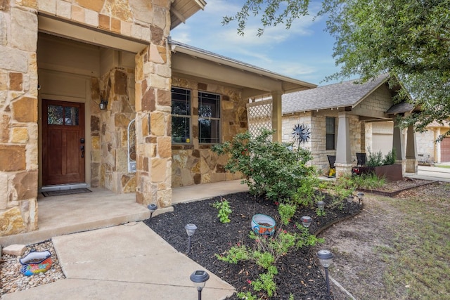doorway to property featuring stone siding and covered porch
