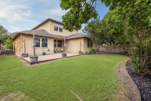 back of house with central AC, a patio area, and roof with shingles