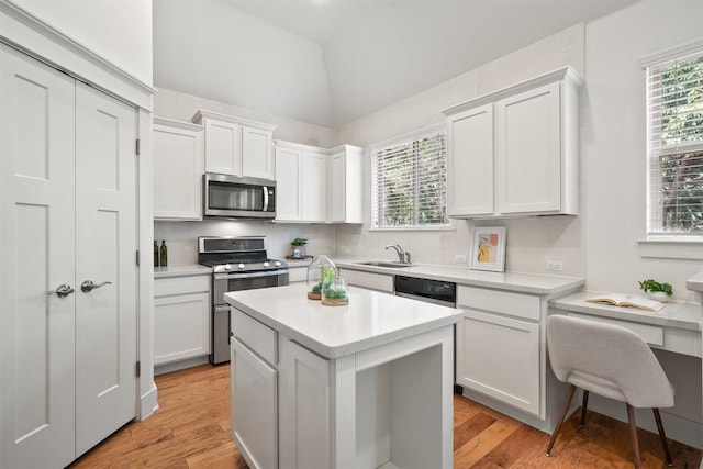 11009 Avery Station Loop Unit 32, Austin, TX 78717 - kitchen featuring appliances with stainless steel finishes, a sink, light countertops, white cabinets, and healthy amount of natural light