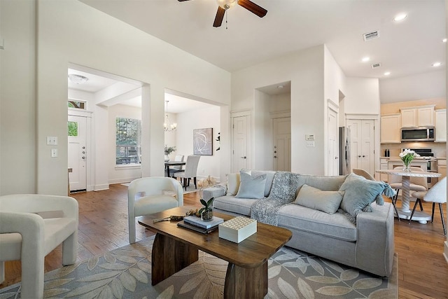 11009 Avery Station Loop Unit 32, Austin, TX 78717 - living room featuring a ceiling fan, wood finished floors, a chandelier, and recessed lighting