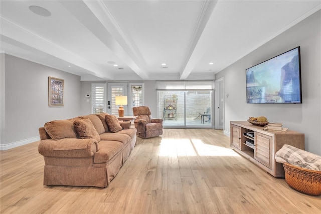 living room with light wood finished floors, baseboards, beam ceiling, and healthy amount of natural light
