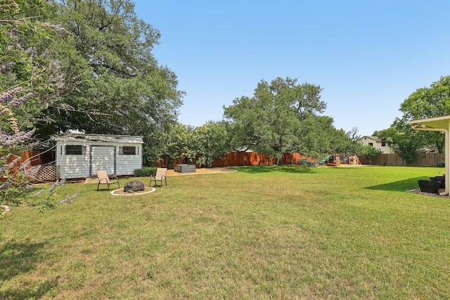 602 Leisurewoods Dr, Buda, TX 78610 - view of yard with a playground, an outdoor fire pit, an outdoor structure, and a shed