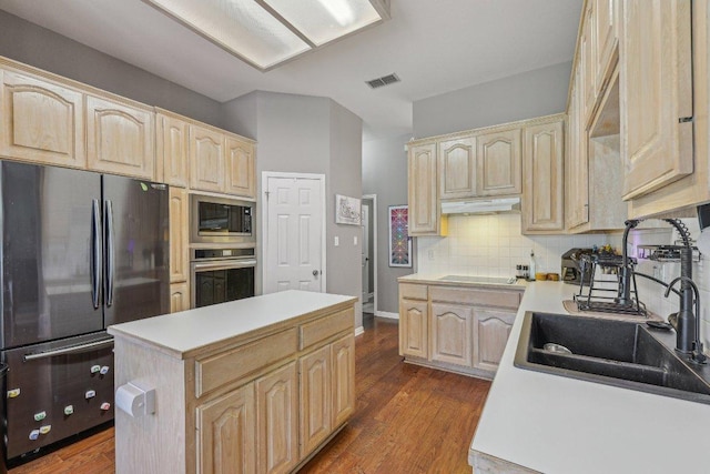 602 Leisurewoods Dr, Buda, TX 78610 - kitchen featuring freestanding refrigerator, light brown cabinets, oven, built in microwave, and under cabinet range hood