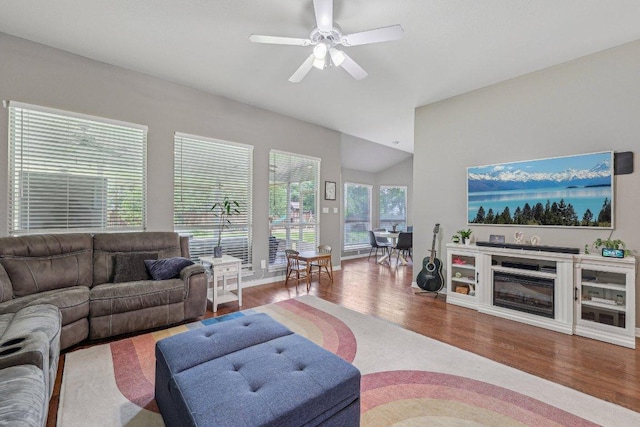 602 Leisurewoods Dr, Buda, TX 78610 - living room featuring wood finished floors, vaulted ceiling, ceiling fan, and baseboards