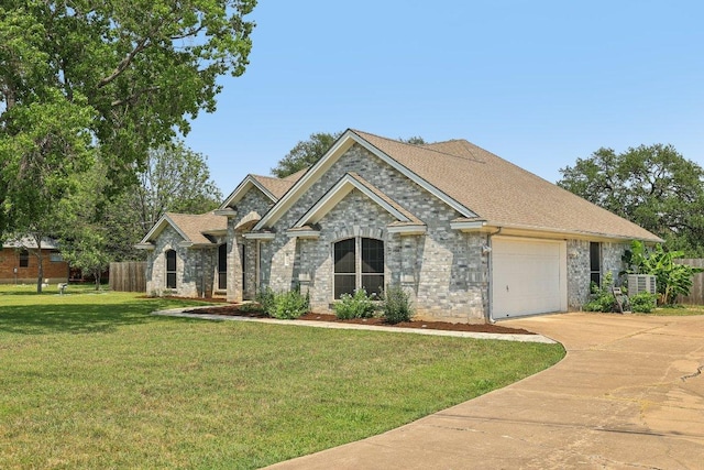 602 Leisurewoods Dr, Buda, TX 78610 - view of front facade featuring an attached garage, driveway, roof with shingles, and central AC