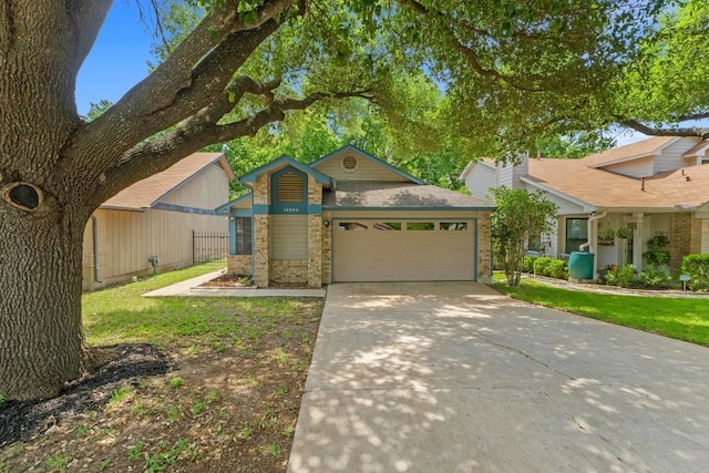 12309 Little Fatima Ln, Austin, TX 78753 - view of front of home with an attached garage, concrete driveway, and brick siding