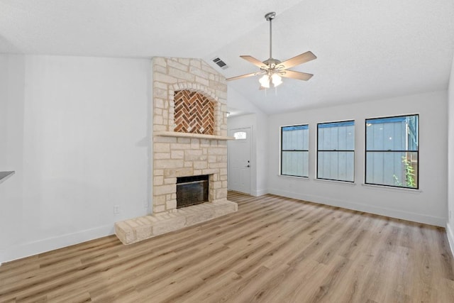 12309 Little Fatima Ln, Austin, TX 78753 - unfurnished living room with a fireplace, ceiling fan, wood finished floors, baseboards, and vaulted ceiling