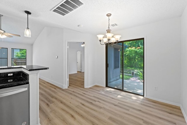 12309 Little Fatima Ln, Austin, TX 78753 - kitchen with light wood-style floors, a chandelier, a ceiling fan, dark countertops, and a textured ceiling
