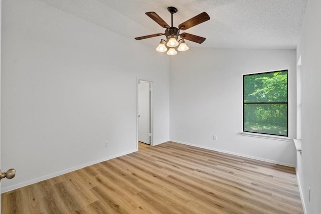 12309 Little Fatima Ln, Austin, TX 78753 - unfurnished room with light wood-type flooring, a ceiling fan, baseboards, lofted ceiling, and a textured ceiling