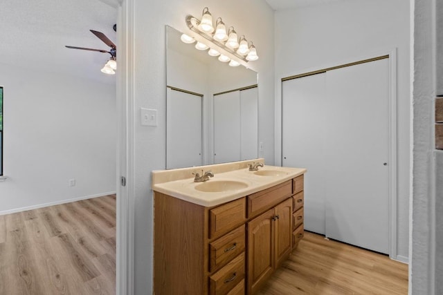 12309 Little Fatima Ln, Austin, TX 78753 - bathroom featuring wood finished floors, a ceiling fan, and double vanity