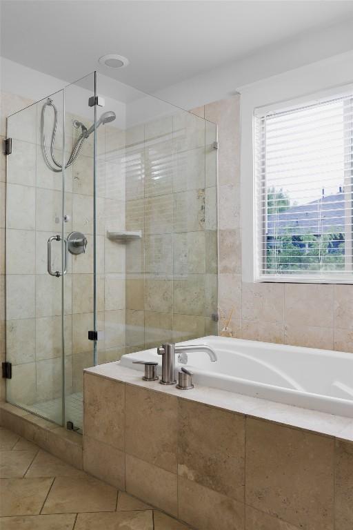 5607 Roosevelt Ave, Austin, TX 78756 - full bathroom featuring a bath, a stall shower, and tile patterned floors