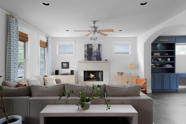 5607 Roosevelt Ave, Austin, TX 78756 - living area with a ceiling fan, finished concrete floors, a lit fireplace, plenty of natural light, and recessed lighting