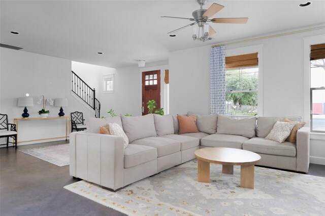 5607 Roosevelt Ave, Austin, TX 78756 - living room featuring stairs, a ceiling fan, and concrete flooring