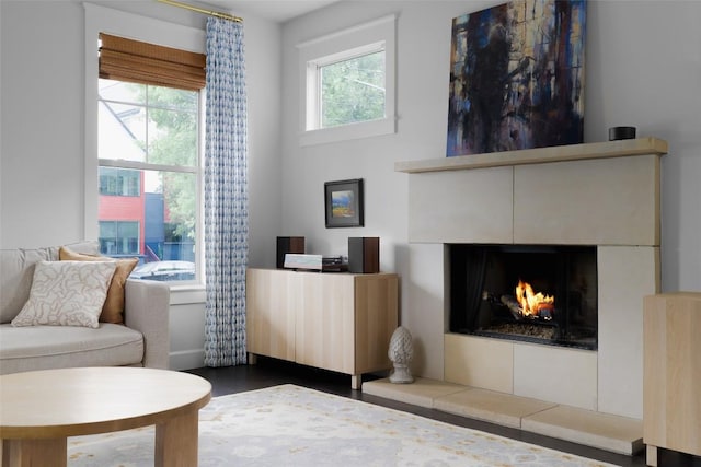 sitting room featuring a tiled fireplace