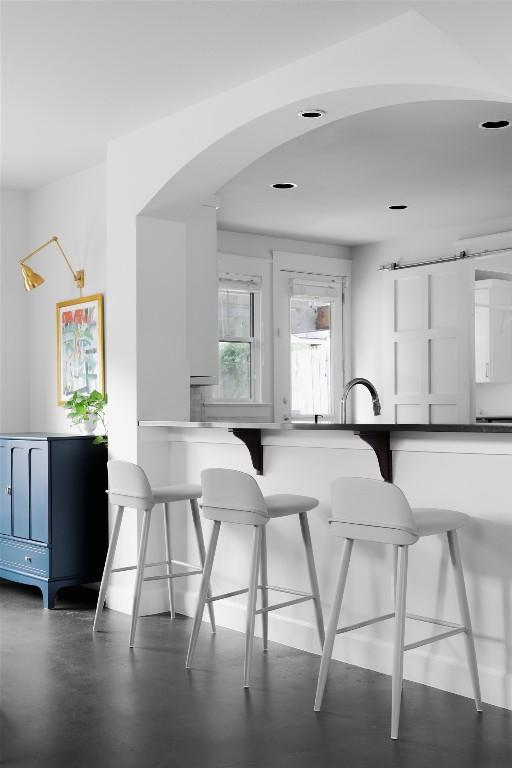5607 Roosevelt Ave, Austin, TX 78756 - kitchen with arched walkways and a breakfast bar area