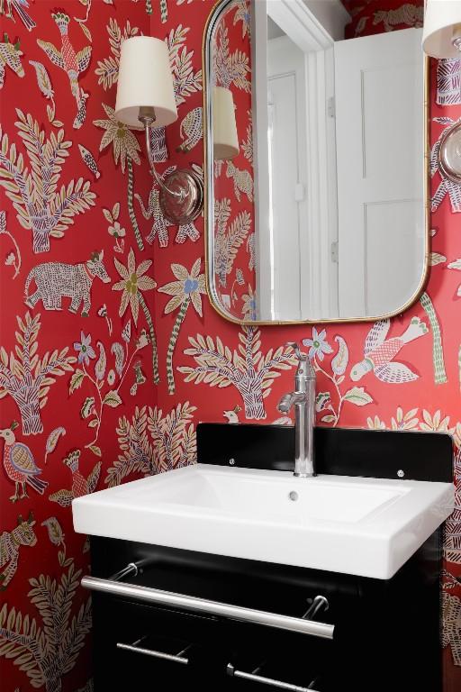 bathroom featuring wallpapered walls and vanity
