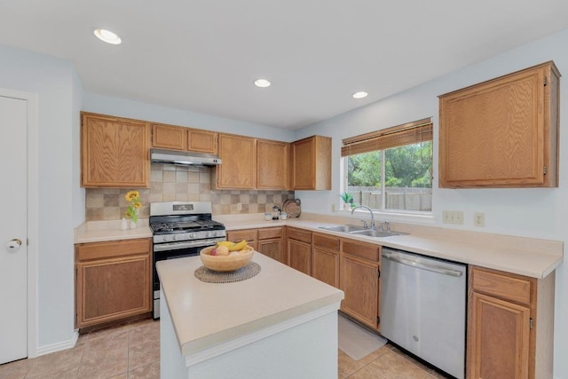 16914 Dorman Dr, Round Rock, TX 78681 - kitchen featuring stainless steel appliances, under cabinet range hood, light countertops, backsplash, and light tile patterned floors