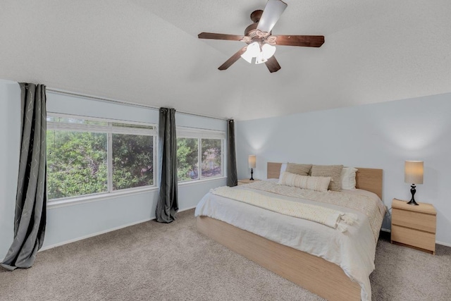 carpeted bedroom with vaulted ceiling, ceiling fan, and baseboards