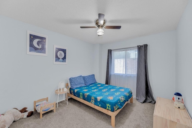 carpeted bedroom with a ceiling fan and a textured ceiling
