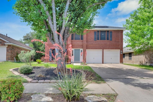 view of front of home featuring concrete driveway, brick siding, an attached garage, and solar panels