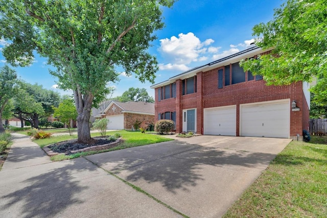 view of front facade featuring brick siding, concrete driveway, an attached garage, and a front yard