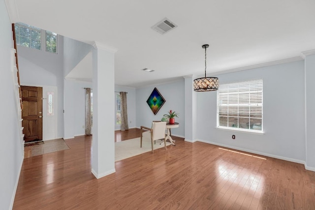 spare room featuring wood finished floors, ornamental molding, and baseboards